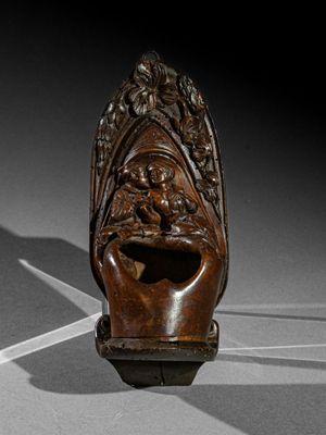 a wooden sculpture of a head with a face on it