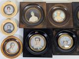 several framed portraits of women are displayed on a wall