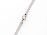 a close up of a wrist watch on a white surface