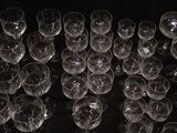 many empty wine glasses sitting on a black table