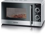 a silver microwave with bacon in it on a white surface
