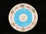 a blue and white plate with pink flowers on it