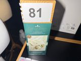 a box that is sitting on a table next to a lamp