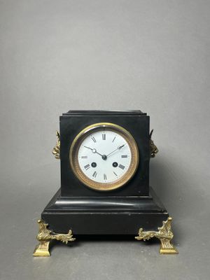 a small clock that is sitting on top of a table