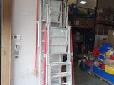 a ladder that is sitting in a garage next to a pile of boxes