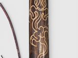 a wooden stick with a design on it next to a pair of scissors