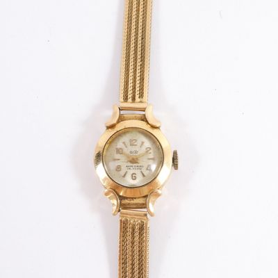 an image of a close up of a wrist watch on a white surface