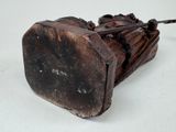 a wooden object that is sitting on a white surface