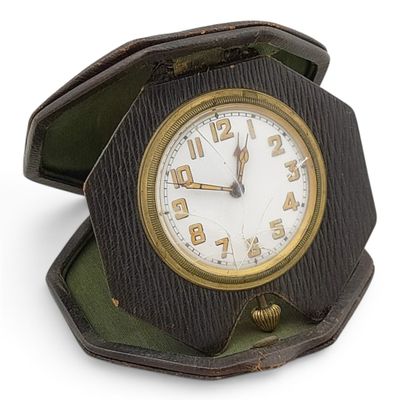 a small wooden clock in a box on a white surface