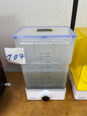two plastic containers with lids sitting on a table
