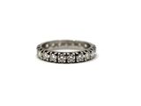 a close up of a diamond ring on a white surface