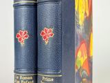 the two books are blue with gold trims on them