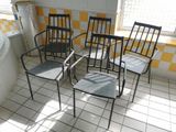 four chairs in a room with yellow and white checkered walls
