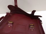 maroon leather handbag with two compartments and a strap