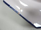 a white plate with a blue edge on a table