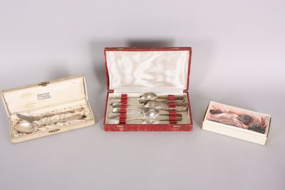 three silverware items in a red case on a table
