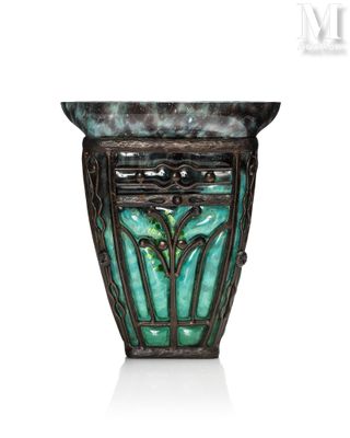 an image of a green vase with a decorative design on it