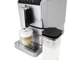 a close up of a coffee machine with a cup of milk