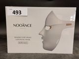 a box with a white mask on it on a table