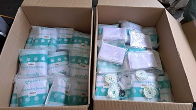 two boxes of diapers that are sitting on a table