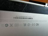 a close up of the back of a laptop with a bar code on it
