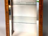 an old wooden display case with glass shelves and shelves