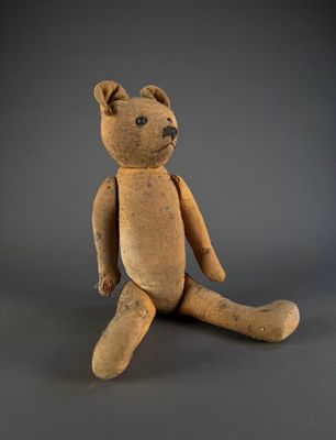 a small teddy bear that is sitting on the ground