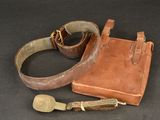 a brown bag and a brown belt on a black surface