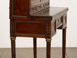 a small desk with a mirror on top of it