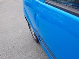 a blue car that is parked on the side of the road
