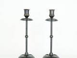 pair of black metal candlesticks with gold accents