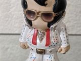 a small figurine of elvis presley wearing sunglasses