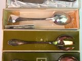 four different types of spoons in a box on a table