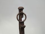 a wooden pole with a metal ring on it