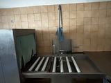 a kitchen with a sink and a metal counter