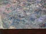 a painting on a wooden table with a cat sitting on it