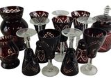 bottles and glasses are lined up in a row on a white surface