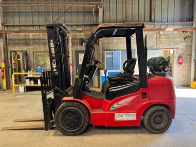 a red forklift truck parked in a warehouse