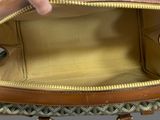 a person holding a purse with a handle in it