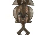 an image of a wooden sculpture of a face on a stand
