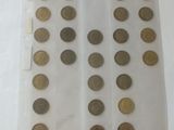 a lot of coins in a plastic bag on a table