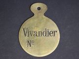 an old brass plate with the name of a woman on it