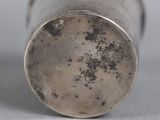 a silver cup that is sitting on a table