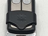 a close up of a car key case with a face on it