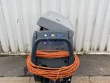 an orange hose attached to a machine on the ground