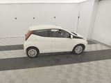 a picture of a small white car parked in a garage