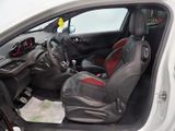 the interior of a small car with red seats and a steering wheel