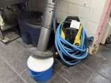 an image of a kitchen with a blue bucket and a vacuum