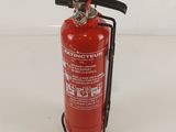 a red fire extinguisor on a white surface