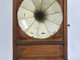 a wooden clock with a white dial on it